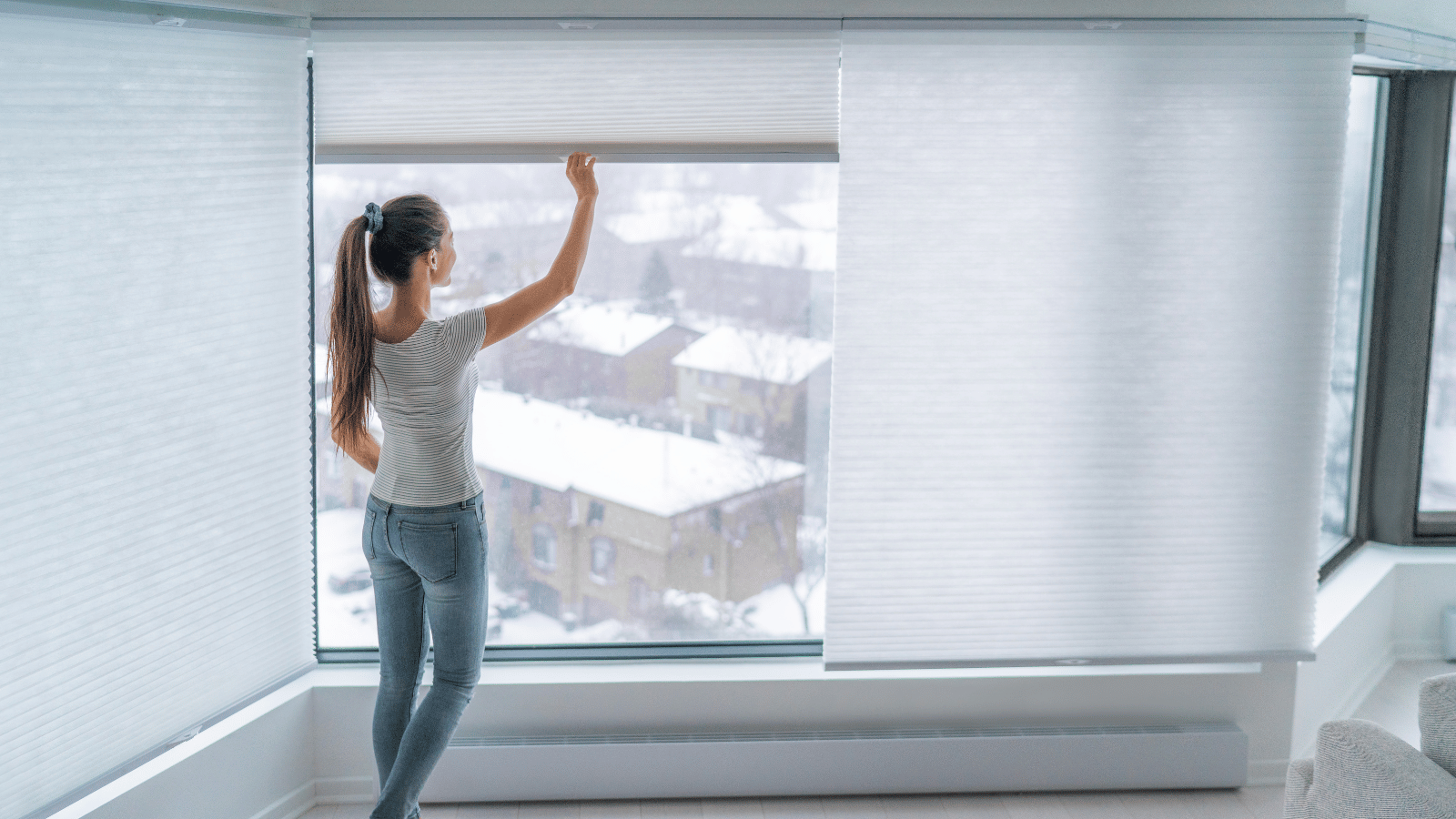 Woman adjusting cordless window covering